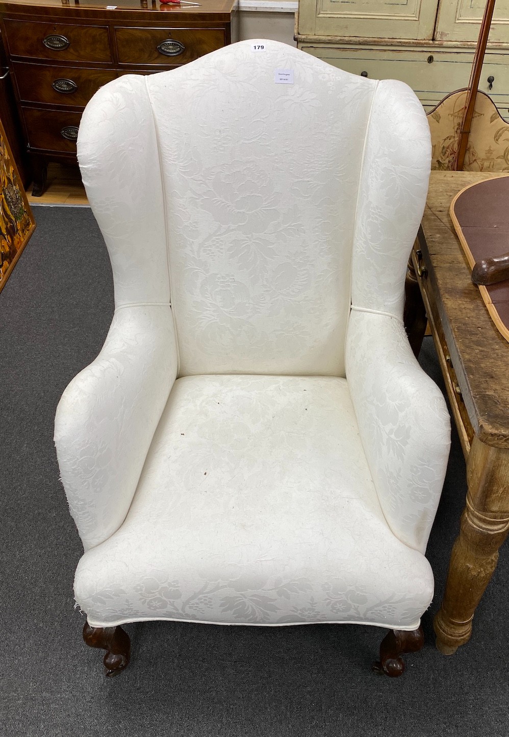 A Victorian upholstered wing armchair, on front cabriole legs, width 70cm, depth 75cm, height 114cm